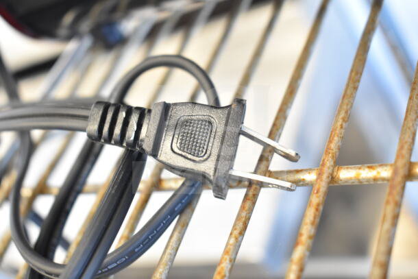 Comfort Zone CZFP1 Electric Fireplace plug, 120V, shows standard black cord and plug design on a metal grate background.