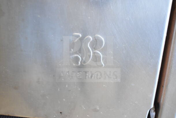 Jade Range logo on stainless steel surface, part of a commercial 6-burner gas range with oven, over shelf, and backsplash.