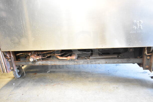 Jade Range commercial gas 6-burner range with oven, over shelf, backsplash, visible wear, on commercial casters.