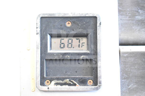 Traulsen G10010 commercial cooler temperature display showing 68.7°F. Used condition, visible dirt and wear.
