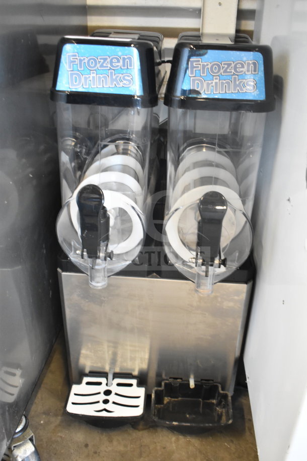Commercial countertop 2-hopper slushie machine, 115 volts, 1 phase. Features "Frozen Drinks" labels, in fair condition.