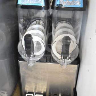 Commercial countertop 2-hopper slushie machine, 115 volts, 1 phase. Features "Frozen Drinks" labels, in fair condition.
