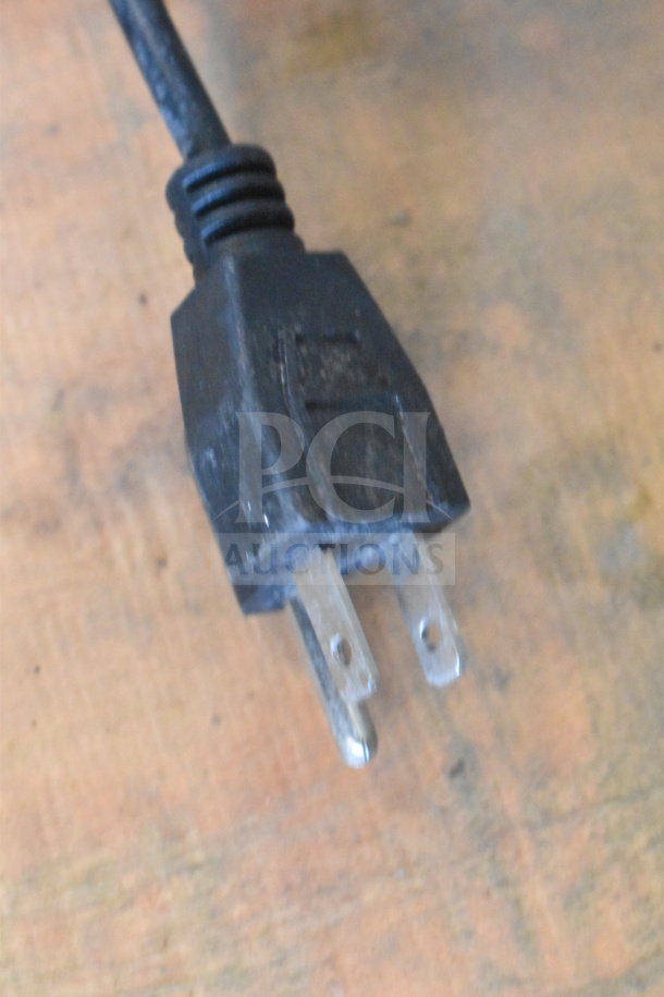 Zeny Countertop Ice Crusher plug, 110-120 Volts, 1 phase; black plug on wooden surface.
