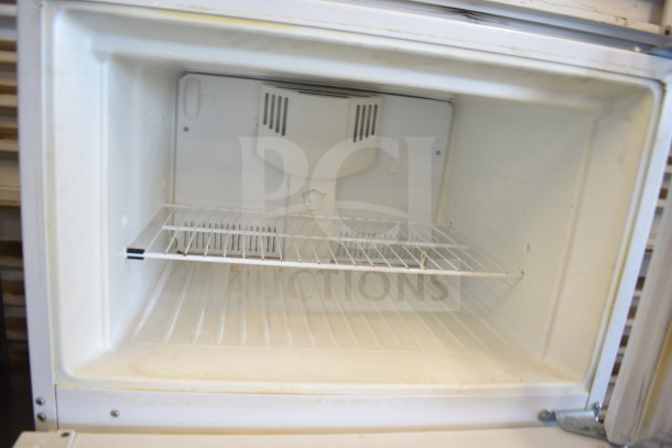 Frigidaire FRT18HS6JW1 cooler with freezer compartment, 115 volts, 1 phase, interior view. Clean with adjustable shelf.