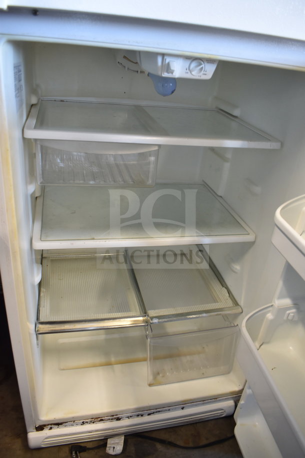 Frigidaire FRT18HS6JW1 reach-in cooler with freezer, 115V, 1 phase. Visible shelves and crisper drawers, some wear.