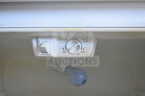 Frigidaire FRT18HS6JW1 fridge control panel showing temperature settings and light bulb.