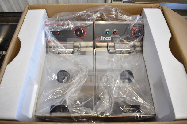 Brand new Winco EFT-32 electric countertop fryer, 2 bays with lids, in original packaging; minor scratches noted.