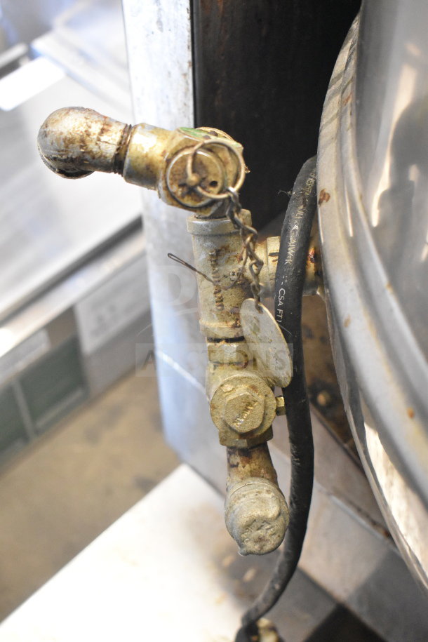 Groen T/1-40 40-gallon steam kettle, propane gas-powered, showing valve and hose connection, some wear visible.