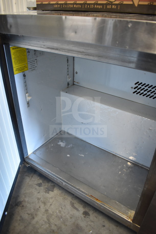 Maxx Cold MXSF60UHC commercial 2-door undercounter freezer, stainless steel, 115 volts, visible interior wear, condition as shown.