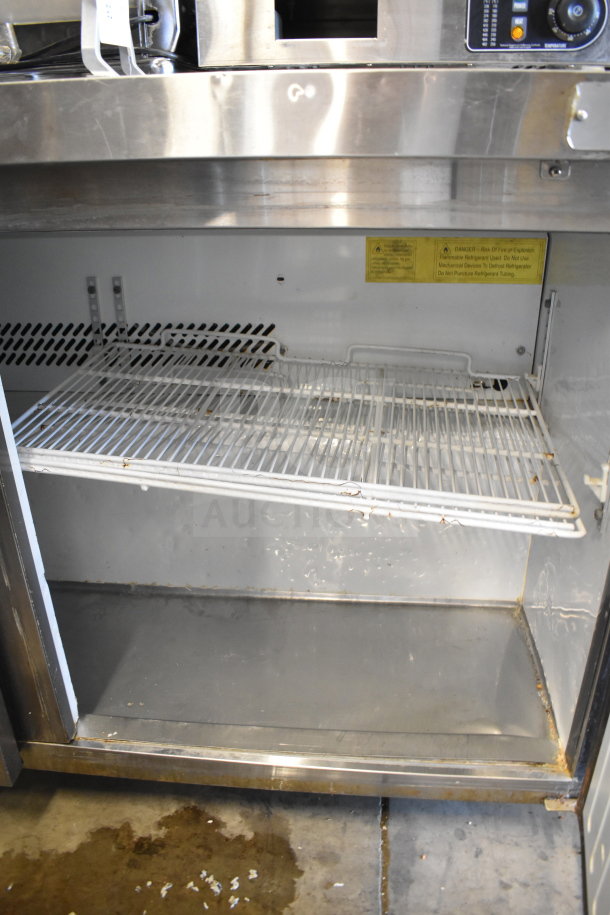 Maxx Cold MXSF60UHC commercial 2-door undercounter freezer, stainless steel, visible shelving, 115 volts, label warnings.
