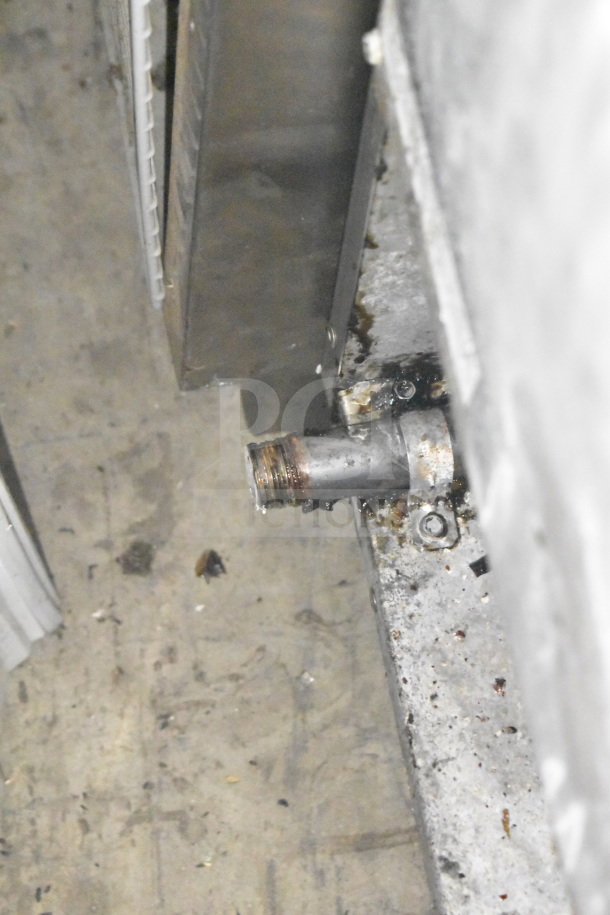 Bakers Pride commercial deep fat fryer with two metal fry baskets. Visible wear and corrosion around the drain pipe.