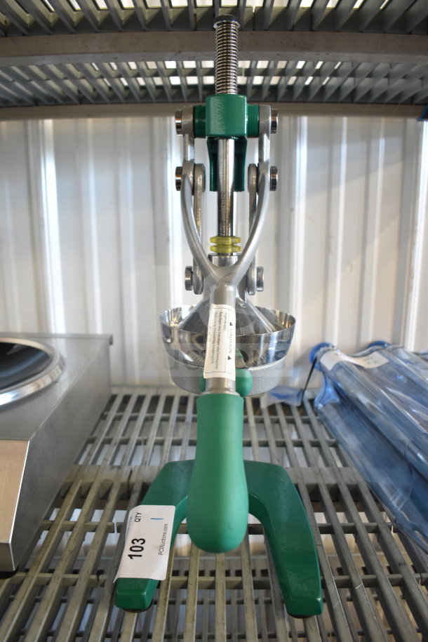 BRAND NEW Garde 181MCJ2 Manual Citrus Juicer, safety spring, green handle, visible caution label, minor scratches.