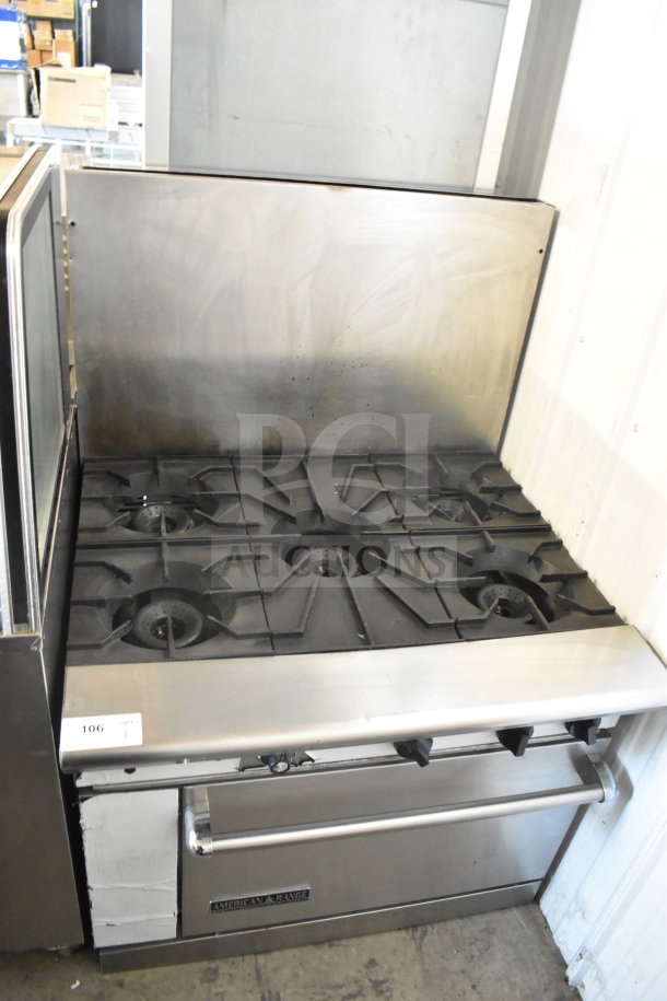 American Range commercial 6-burner gas range with oven, stainless steel, includes backsplash, shows moderate wear.