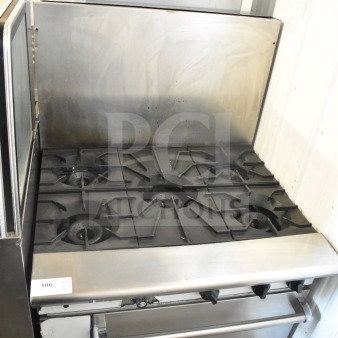 American Range commercial 6-burner gas range with oven, stainless steel, includes backsplash, shows moderate wear.