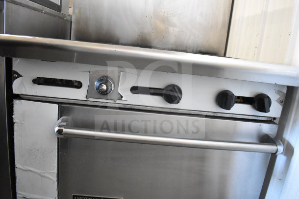 American Range commercial gas-powered 6 burner stove with oven and backsplash, featuring control knobs and oven handle.