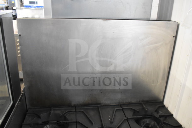 American Range commercial gas 6-burner stove with oven and backsplash, in used condition, visible wear on surface.