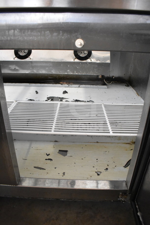 Cooltech CTR-60BMBTG prep table display case with electrical components exposed, showing wear and debris inside.