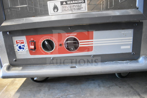 Metro C539-HDC-4-GY heated holding cabinet control panel with temperature dial and warning label, on commercial casters.