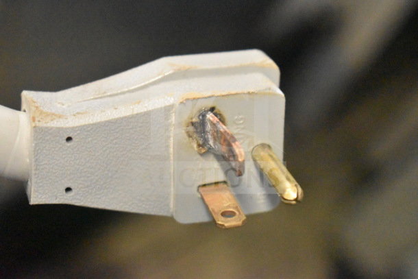Close-up of a three-prong plug for the Metro C539-HDC-4-GY heated holding cabinet. Plug shows signs of wear.