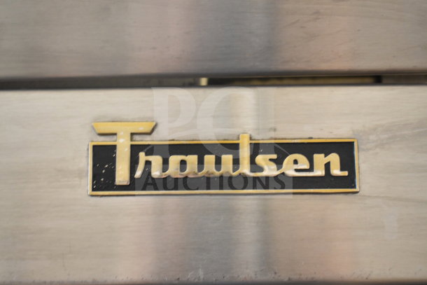 Traulsen RHT132WPTHHG logo on stainless steel surface; commercial cooler missing doors, 115 volts, 1 phase.