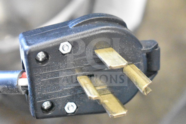 Close-up of the plug for a 2022 Precision Mixer HD-60, 220 volts, 3 phase, showing prongs and screw details.