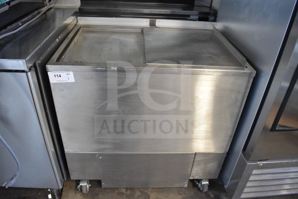 H&K 52473-1 commercial chest freezer, stainless steel, 120 volts, 1 phase, mounted on wheels, auction tag visible.
