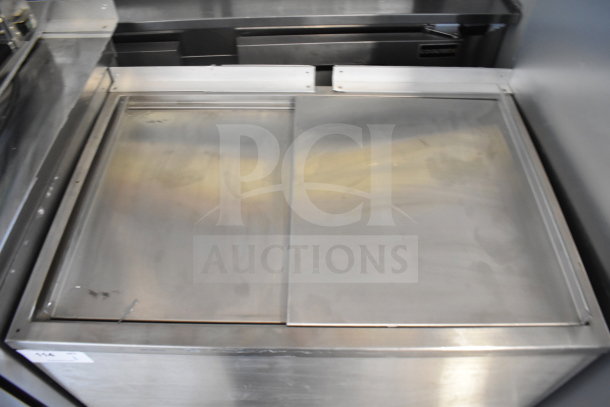 H&K 52473-1 Commercial Chest Freezer, 120V, 1 Phase. Stainless steel exterior, sliding top doors, minor wear visible.