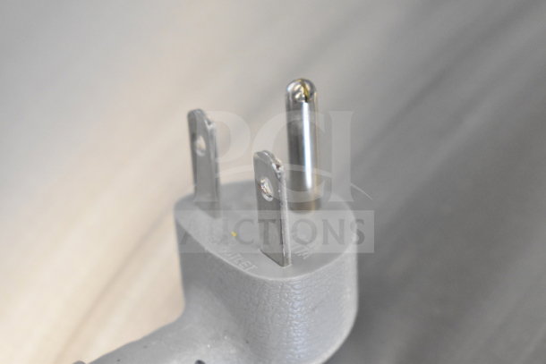 Close-up of a three-prong industrial-grade plug for the Sharp R-CD1800M commercial microwave, 208/230 volts.