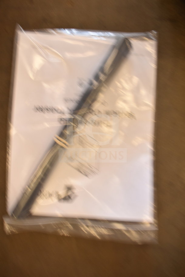 Blurred image of packaging and manuals for a 2021 AJ Antunes BKT-2V Commercial Countertop Vertical Contact Toaster.