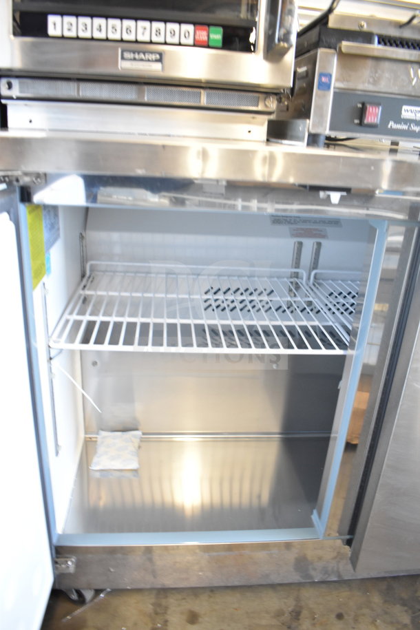 Arctic Air AUC48RZ commercial 2-door undercounter cooler, 115 volts, shown open to reveal shelving and interior space.
