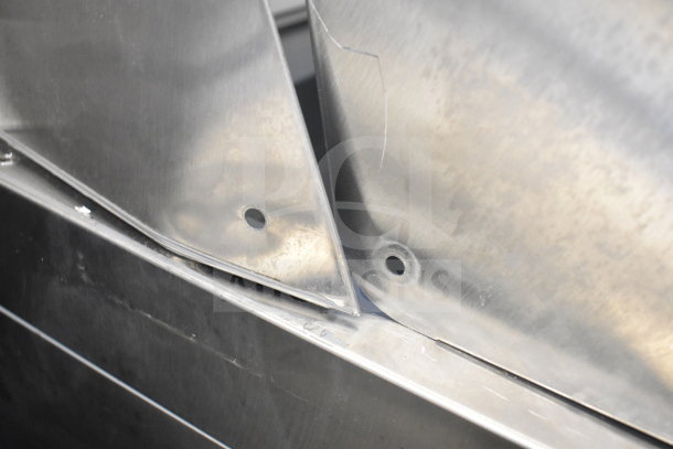 Avantco commercial sandwich salad prep table with visible metal components, showing construction details, 115 volts, 1 phase.