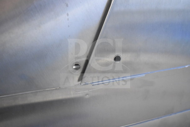 Close-up of Avantco Commercial Prep Table surface, showcasing stainless steel construction and pre-drilled holes.