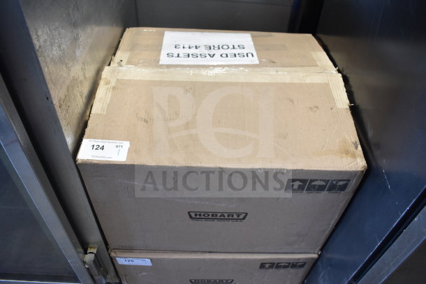 Cardboard box with Hobart branding, likely containing a 2020 Hobart HTi-7LH4W Commercial Scale. Box shows storage wear.