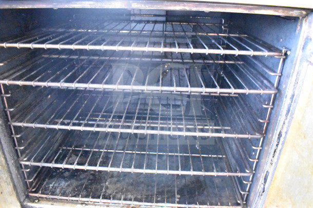 Royal RCOS-1 convection oven interior view, showing multiple wire racks and clean surfaces, part of a commercial oven set.