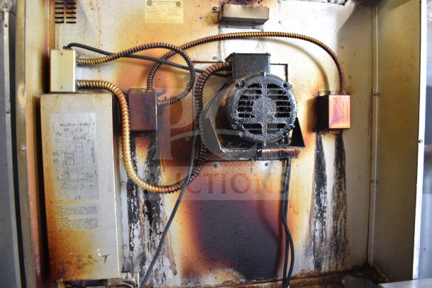 Interior view of a Royal RCOS-1 convection oven showing the motor, wiring, and some rust and oil stains, indicating use.