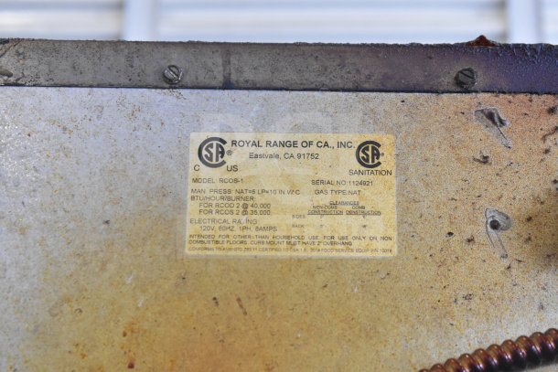 Royal RCOS-1 convection oven label showing model, electrical rating, gas type, and pressure specs. Slight wear visible.
