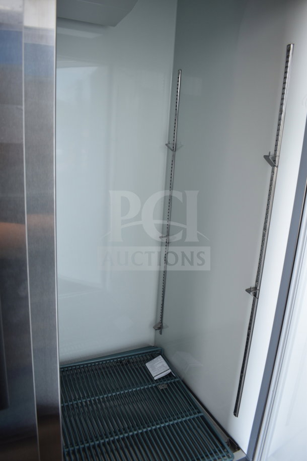 Brand new Avantco 178A49FHC commercial 2-door freezer interior, showing stainless steel finish and adjustable shelving.