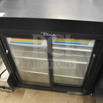 2021 True GDM-09-SQ-HC-LD 2-door reach-in cooler merchandiser, black, with glass doors and interior shelves, used condition.