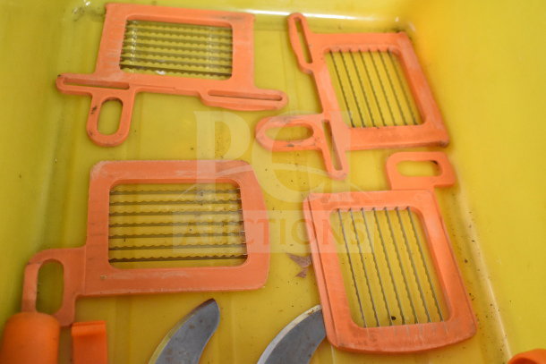 Dynacube vegetable cutter accessories, including orange grid inserts and curved blades, shown in a yellow container.