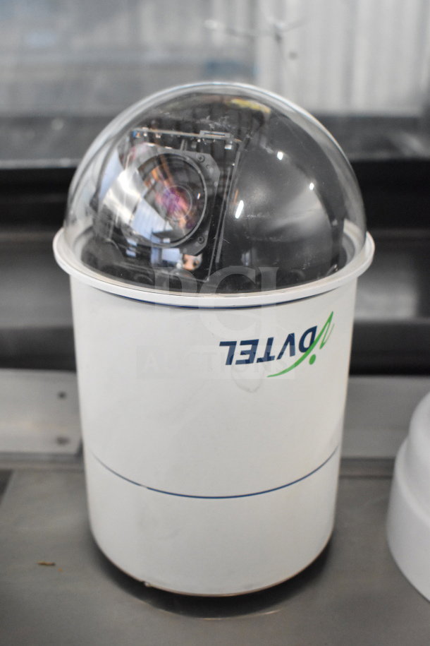Security dome camera by AVTEL, with clear housing, visible internal lens, in good condition. Auction for 14 units.