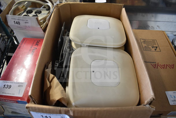 8 Cisco AIR-CAP3502I-A-K9 access points in a box, lightly used, with visible branding, ideal for network expansion.