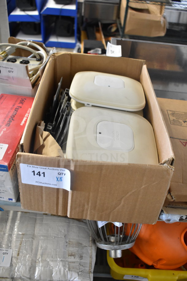 8 Cisco AIR-CAP3502I-A-K9 Access Points in a cardboard box, visible labels, used condition, model marking on devices.