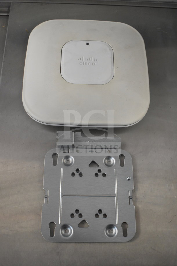 Cisco AIR-CAP3502I-A-K9 access point with mounting bracket. Used condition, eight units available.