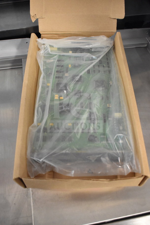 Two Avaya circuit boards in a box, sealed in plastic, showing components and chips. Auction includes double your bid.