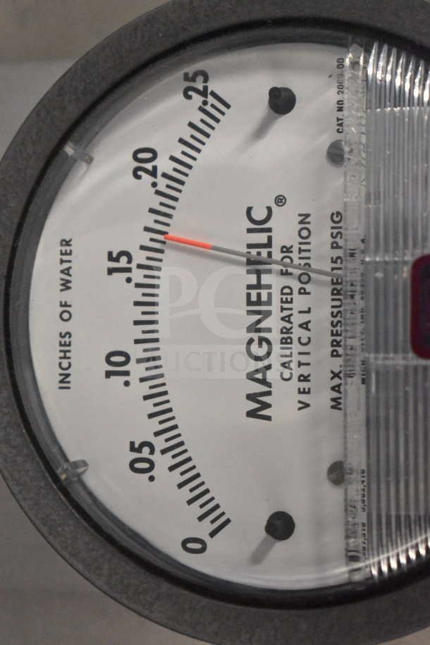 Magnehelic gauge displaying inches of water. Calibrated for vertical position, max pressure 15 PSIG. Clear markings.