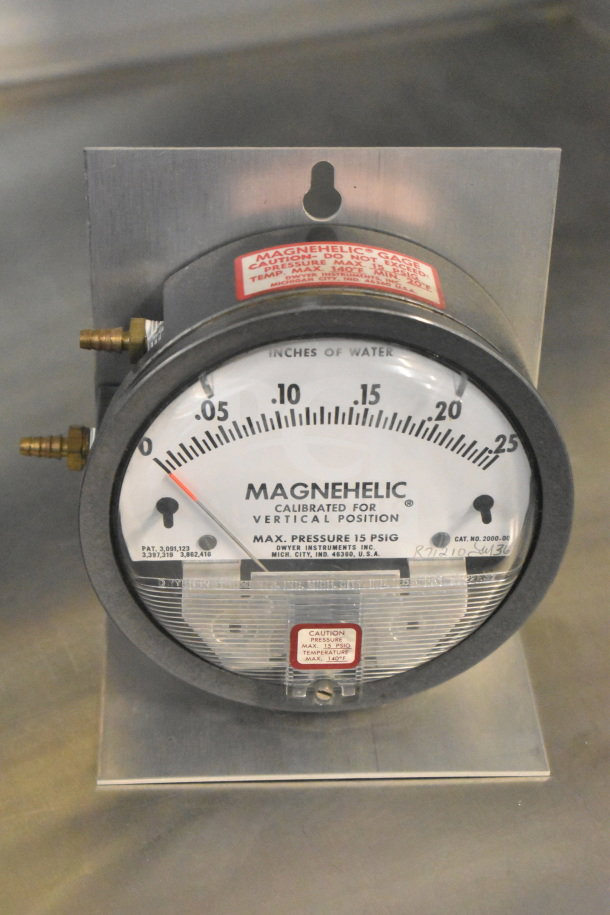 Magnehelic gauge by Dwyer Instruments, measures up to 0.25 inches of water, max pressure 15 PSIG, metal mounting plate.