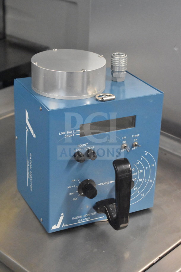 2 GA-100 radon monitor, blue casing, visible dials and controls, low battery indicator, includes handle, good condition.