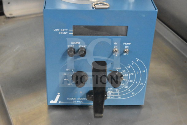 GA-100 Radon Monitor, blue casing, control knobs, switches for HV and pump. Marked "LOW BATT." with operational settings visible.
