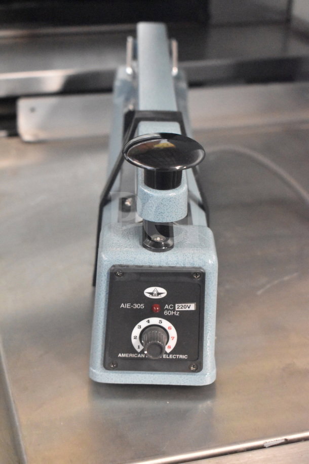 American International Electric AIE-305 Impulse Sealer, 220V, in good condition, with control dial and power markings visible.