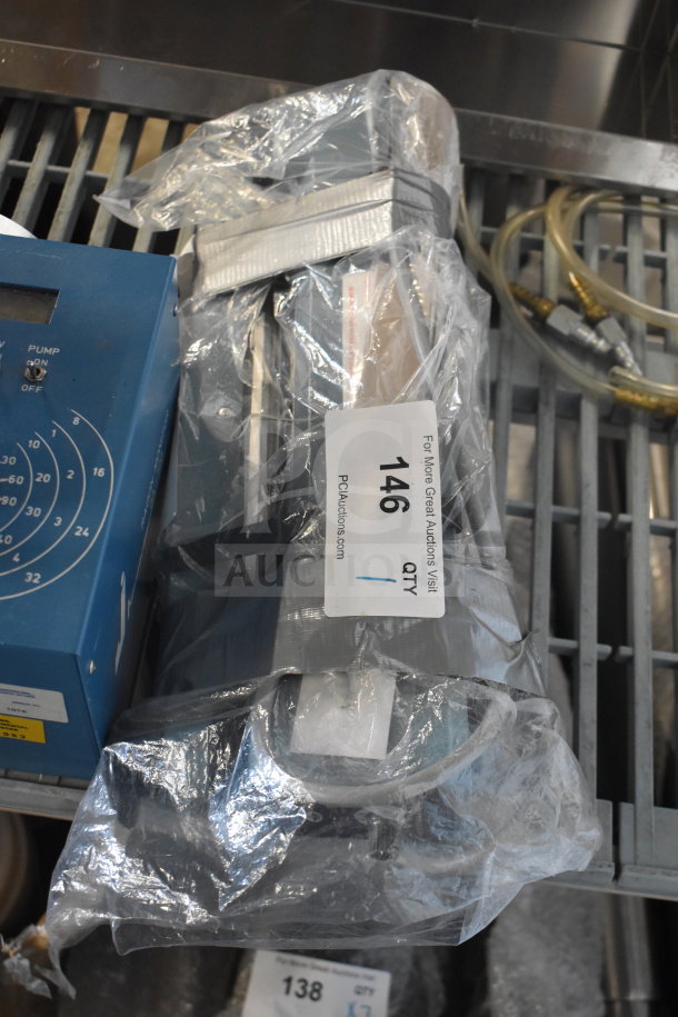 American International Electric AIE-305 impulse sealer, 220 volts, wrapped in plastic, with auction tag visible.